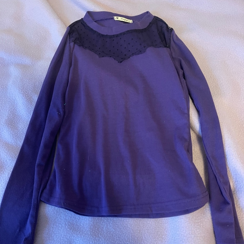 Purple shirt with black lace around the neck